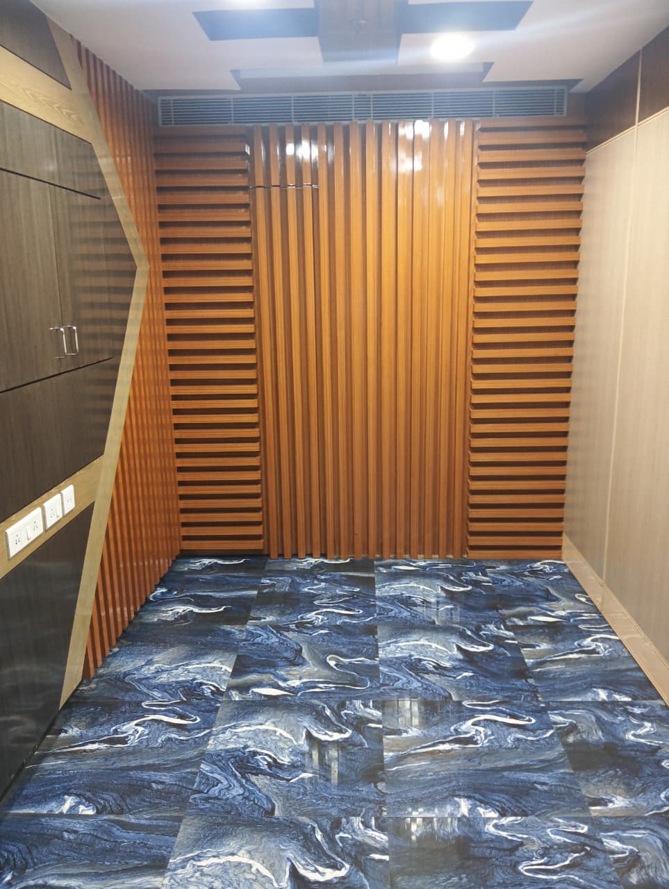A smaller adjoining room finished in wood panelling.